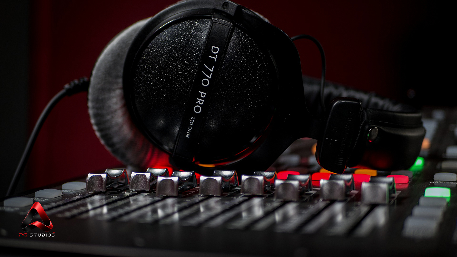 Studio headphones on an audio mixing console