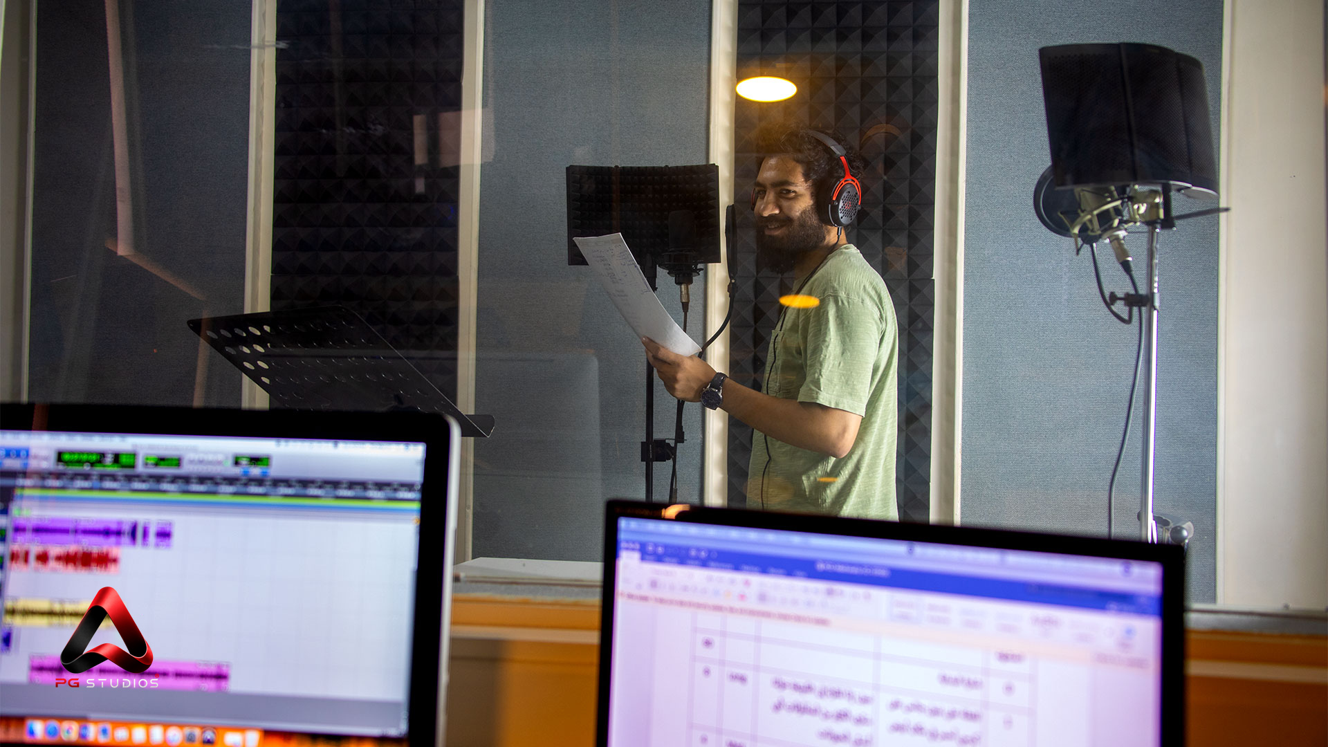 Voice artist recording in a PG Studios booth