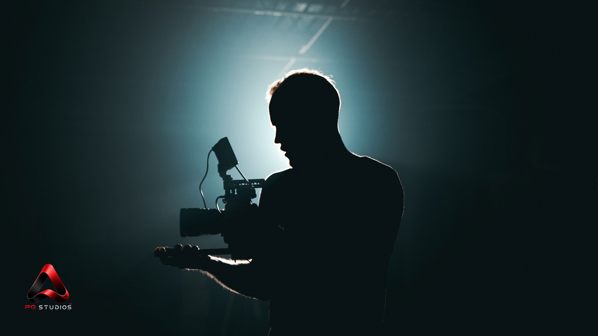 Camera operator silhouetted on a PG Studios set